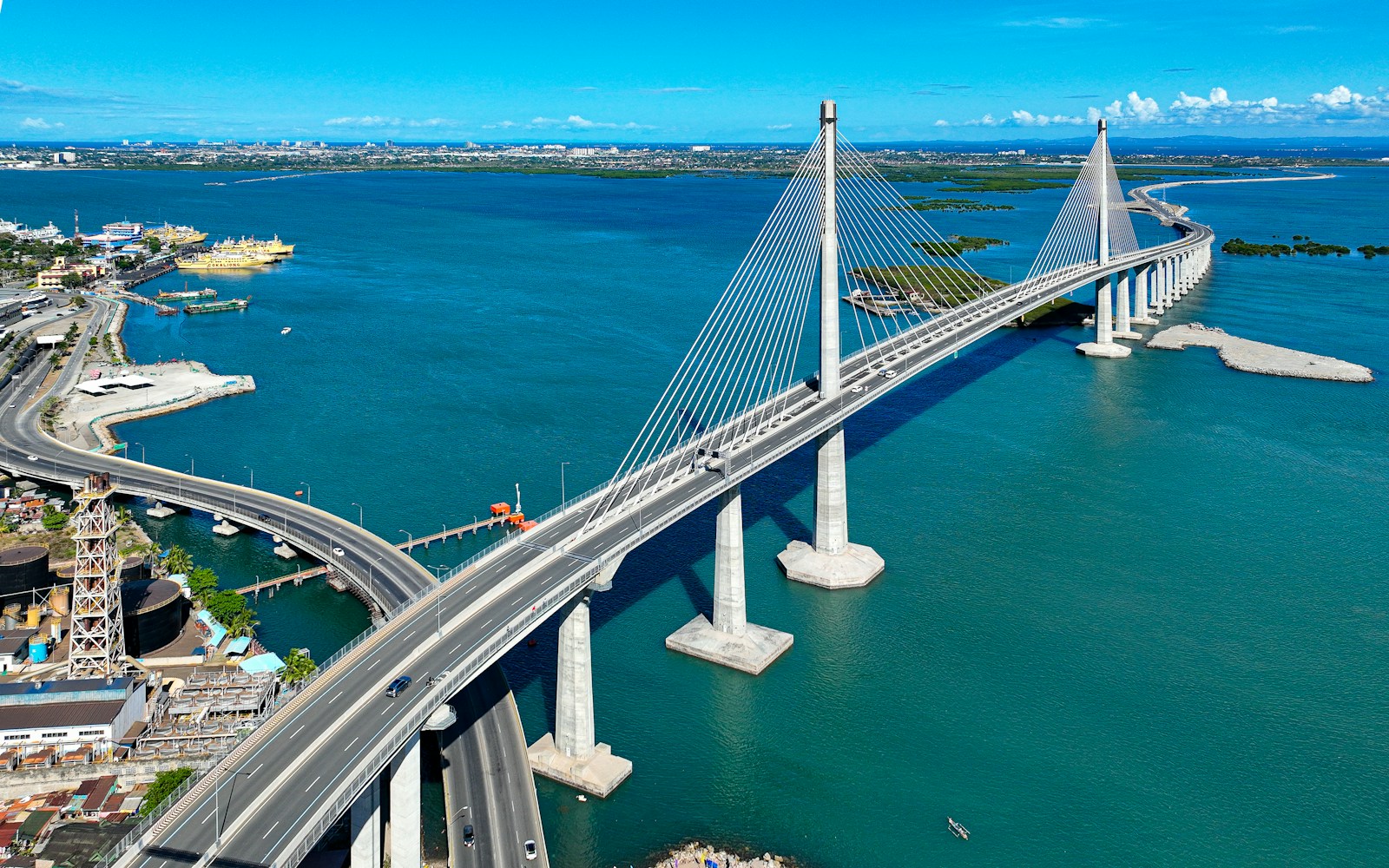 Cable-stayed bridge over coastal waters at sunset